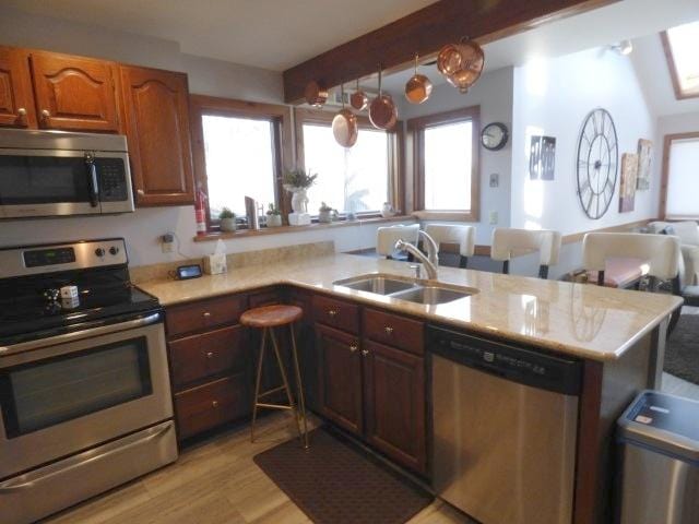 2 Tamarack Row, Galena, IL 61036 - kitchen with stainless steel appliances, a sink, light countertops, beam ceiling, and a peninsula