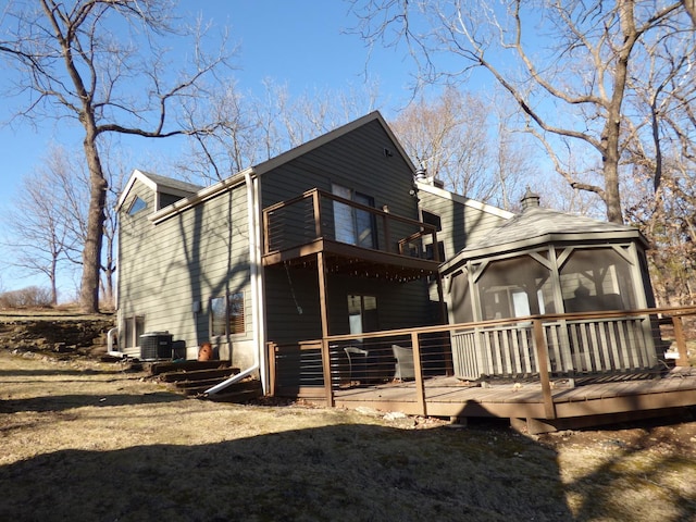 2 Tamarack Row, Galena, IL 61036 - back of house with a balcony, a chimney, a wooden deck, central AC, and a sunroom