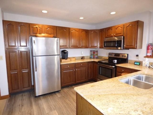 2 Tamarack Row, Galena, IL 61036 - kitchen featuring appliances with stainless steel finishes, a sink, light wood-type flooring, brown cabinetry, and recessed lighting