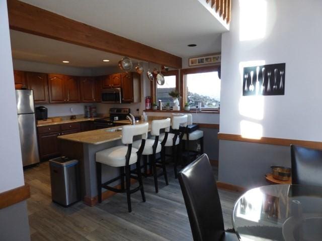 2 Tamarack Row, Galena, IL 61036 - kitchen with stainless steel appliances, dark wood finished floors, a kitchen breakfast bar, recessed lighting, and beam ceiling