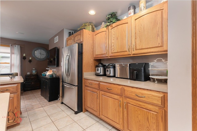 2598 N 2739th Rd, Marseilles, IL 61341 - kitchen with freestanding refrigerator, light countertops, and light tile patterned flooring