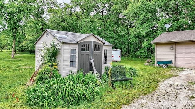 2598 N 2739th Rd, Marseilles, IL 61341 - view of shed with a garage and view of wooded area