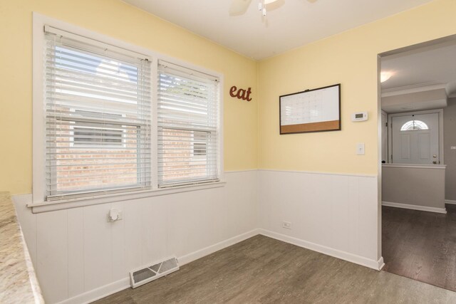 6136 N Nagle Ave, Chicago, IL 60646 - spare room featuring dark wood finished floors, wainscoting, and ceiling fan