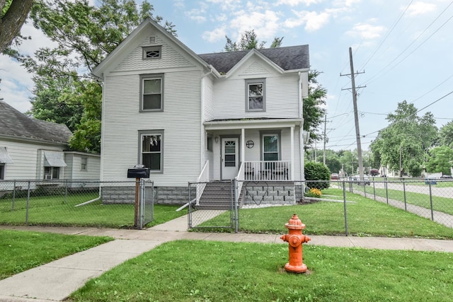 904 E Madison St, Pontiac, IL 61764 - victorian house featuring a porch, a fenced front yard, a gate, and roof with shingles