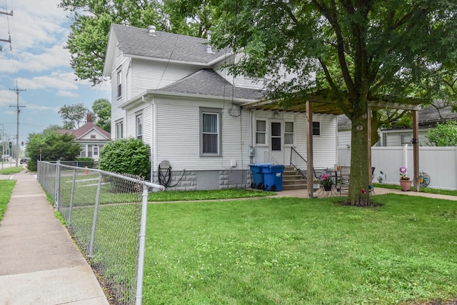 904 E Madison St, Pontiac, IL 61764 - rear view of house with a shingled roof and entry steps