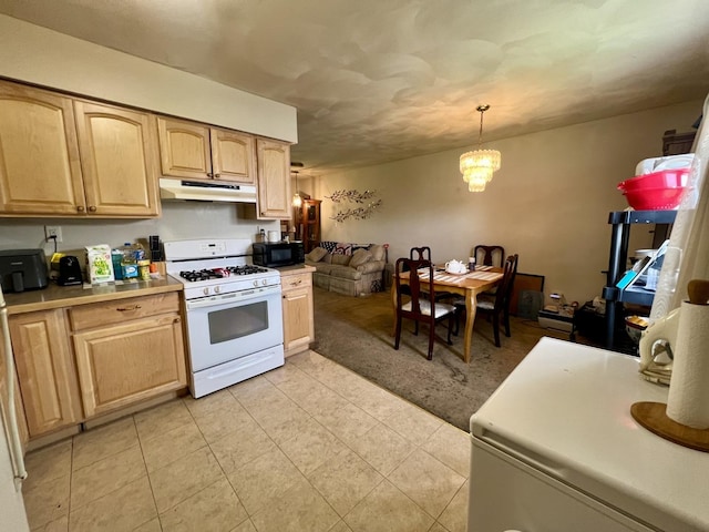 1405 W Beech St, Urbana, IL 61801 - kitchen featuring white gas stove, under cabinet range hood, black microwave, and light brown cabinets