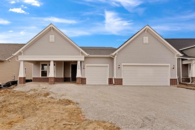 3245 Lincoln Prairie Blvd, Aurora, IL 60503 - view of front of property featuring an attached garage, a porch, driveway, and brick siding