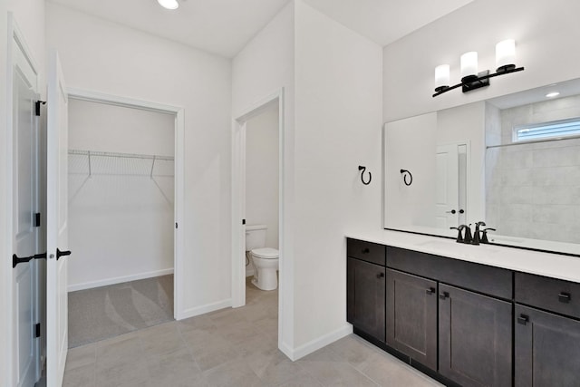 3245 Lincoln Prairie Blvd, Aurora, IL 60503 - full bathroom with toilet, vanity, a spacious closet, baseboards, and tile patterned floors