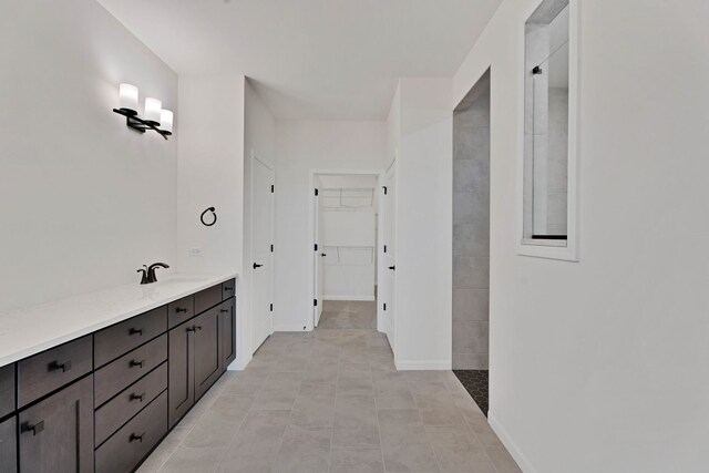 3245 Lincoln Prairie Blvd, Aurora, IL 60503 - full bathroom with a walk in closet, vanity, tiled shower, tile patterned flooring, and baseboards