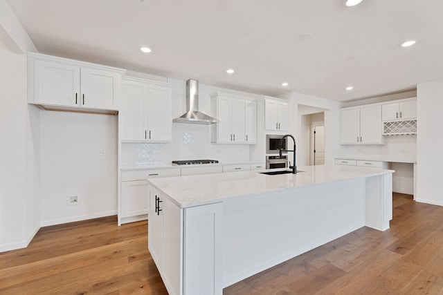3245 Lincoln Prairie Blvd, Aurora, IL 60503 - kitchen with wall chimney range hood, gas stovetop, a spacious island, backsplash, and a sink