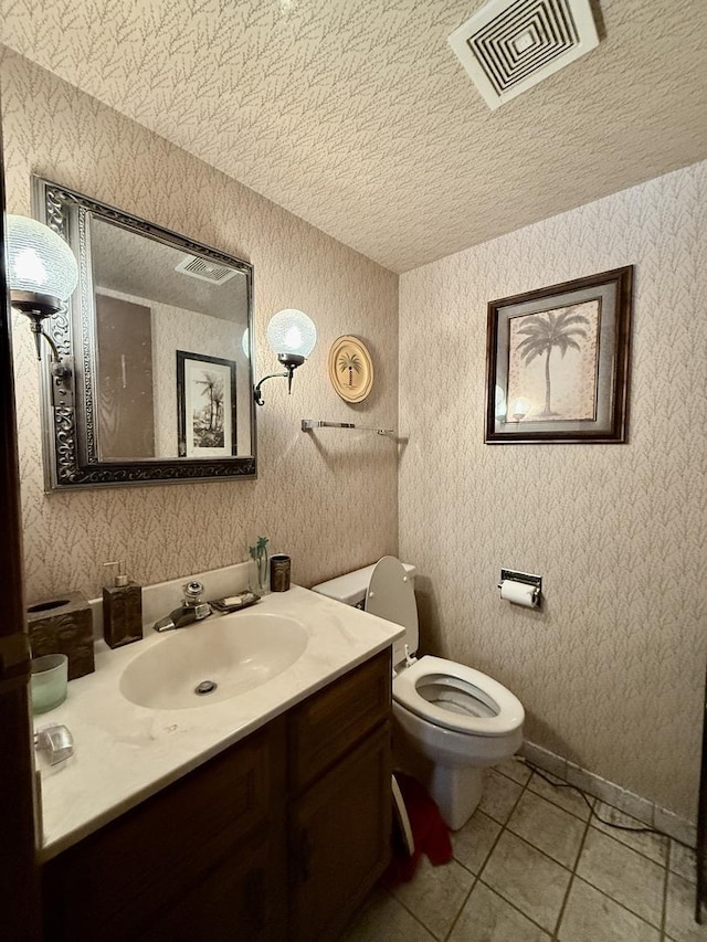 1545 Winnetka Rd Unit 1545, Glenview, IL 60025 - bathroom with a textured ceiling, vanity, toilet, tile patterned floors, and wallpapered walls