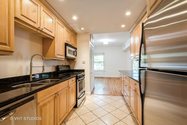 4148 N Clarendon Ave Unit 102, Chicago, IL 60613 - kitchen with stainless steel appliances, recessed lighting, light tile patterned flooring, dark stone countertops, and light brown cabinets