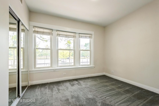 4148 N Clarendon Ave Unit 102, Chicago, IL 60613 - empty room with plenty of natural light and dark carpet