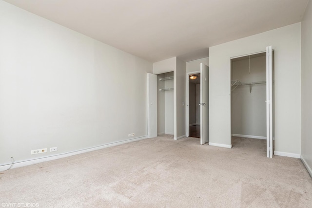 525 W Hawthorne Pl Unit 2701, Chicago, IL 60657 - unfurnished bedroom with carpet floors, two closets, and baseboards