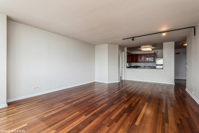 525 W Hawthorne Pl Unit 2701, Chicago, IL 60657 - unfurnished living room with dark wood-style flooring, track lighting, and baseboards