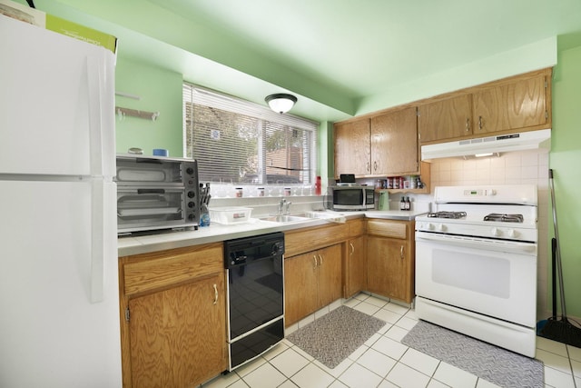 6850 Cermak Rd Unit Gb, Berwyn, IL 60402 - kitchen with white appliances, under cabinet range hood, a sink, light countertops, and light tile patterned floors