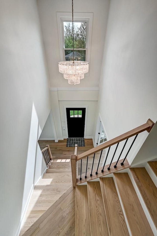 4468 Clausen Ave, Western Springs, IL 60558 - foyer featuring a chandelier, wood finished floors, a towering ceiling, and stairway