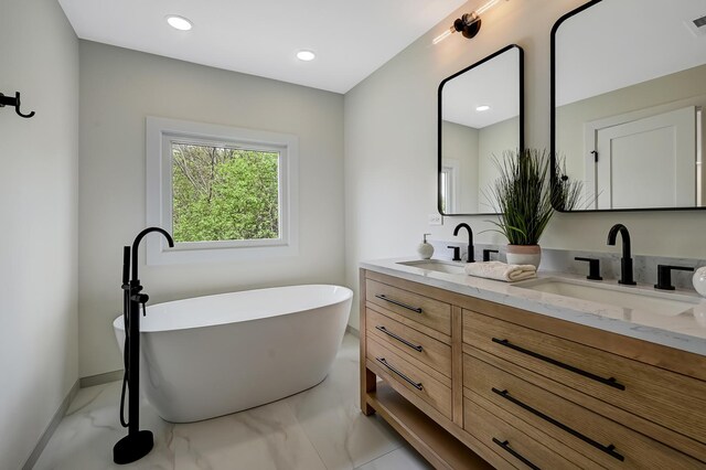 4468 Clausen Ave, Western Springs, IL 60558 - bathroom featuring marble look tiles, double vanity, a soaking tub, baseboards, and recessed lighting