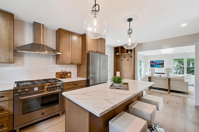4468 Clausen Ave, Western Springs, IL 60558 - kitchen with appliances with stainless steel finishes, wall chimney exhaust hood, open floor plan, light wood finished floors, and recessed lighting