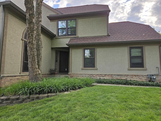 121 Chatsworth Cir, Schaumburg, IL 60194 - view of front of home featuring a front lawn, stucco siding, brick siding, and roof with shingles