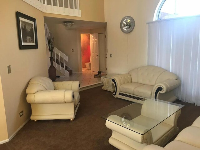 121 Chatsworth Cir, Schaumburg, IL 60194 - living area with carpet, a towering ceiling, stairs, and baseboards
