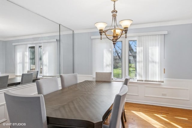 20832 Sparta Ln, Olympia Fields, IL 60461 - dining space with ornamental molding, a chandelier, wood finished floors, a decorative wall, and wainscoting