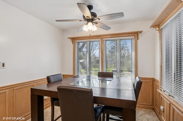 20832 Sparta Ln, Olympia Fields, IL 60461 - dining area featuring wainscoting, a ceiling fan, and a decorative wall