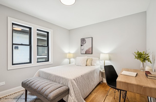 4102 W Eddy St, Chicago, IL 60641 - bedroom featuring baseboards, light wood-type flooring, and a desk