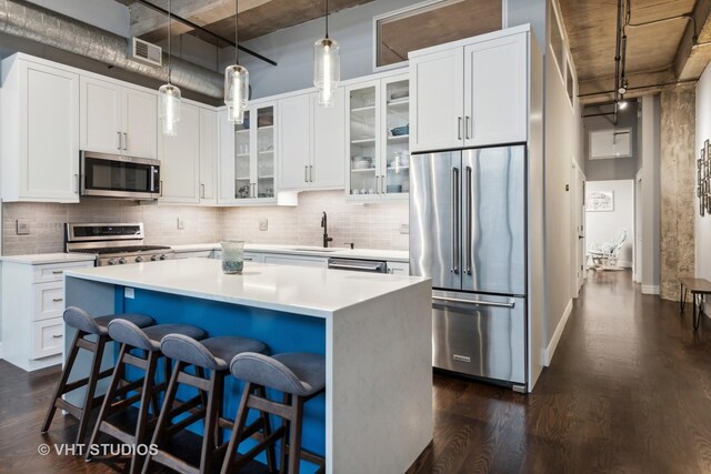 843 W Adams St Unit 310, Chicago, IL 60607 - kitchen with appliances with stainless steel finishes, decorative backsplash, dark wood finished floors, and glass insert cabinets
