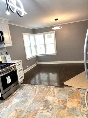1900 W 83rd St Unit 0, Chicago, IL 60620 - kitchen with stainless steel appliances, crown molding, and white cabinetry