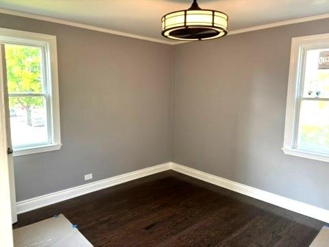 1900 W 83rd St Unit 0, Chicago, IL 60620 - empty room with dark wood-style flooring and ornamental molding