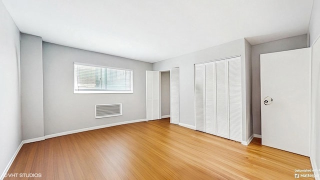 1567 Ridge Ave Unit 307, Evanston, IL 60201 - unfurnished bedroom with light wood finished floors and multiple closets