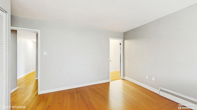 1567 Ridge Ave Unit 307, Evanston, IL 60201 - empty room with a baseboard radiator and light wood finished floors
