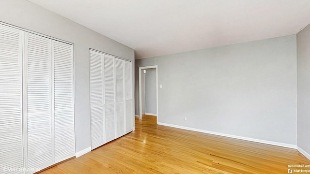 1567 Ridge Ave Unit 307, Evanston, IL 60201 - unfurnished bedroom with light wood finished floors and two closets