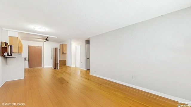 1567 Ridge Ave Unit 307, Evanston, IL 60201 - unfurnished living room with light wood-type flooring and baseboards