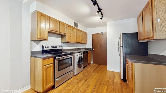 1567 Ridge Ave Unit 307, Evanston, IL 60201 - kitchen featuring stainless steel appliances, dark countertops, light wood-type flooring, rail lighting, and washer / clothes dryer