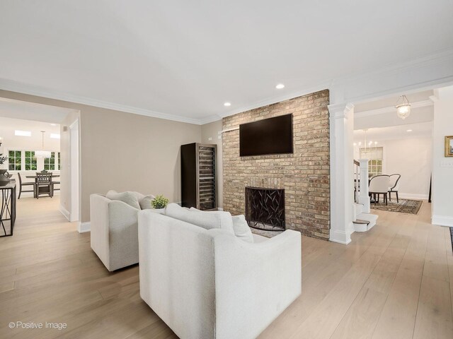 1360 Turvey Rd, Downers Grove, IL 60515 - living area featuring light wood finished floors, a fireplace, crown molding, recessed lighting, and a chandelier