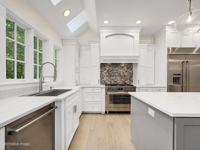 1360 Turvey Rd, Downers Grove, IL 60515 - kitchen with high end appliances, a skylight, light wood-type flooring, light countertops, and recessed lighting