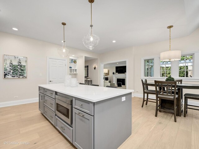 1360 Turvey Rd, Downers Grove, IL 60515 - kitchen featuring gray cabinetry, light wood finished floors, stainless steel microwave, light countertops, and recessed lighting