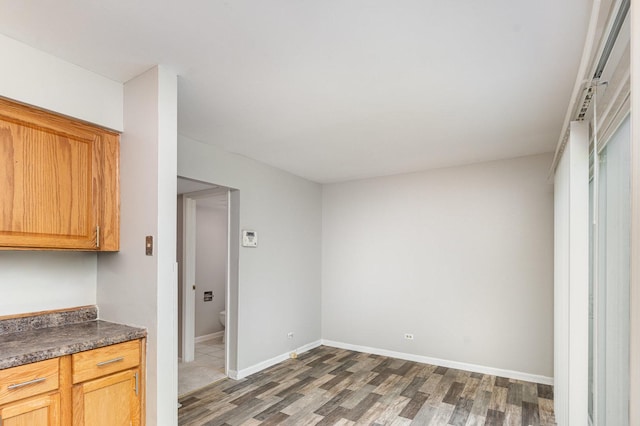 2265 Windsor Ln, Country Club Hills, IL 60478 - kitchen featuring wood finished floors, dark countertops, and baseboards