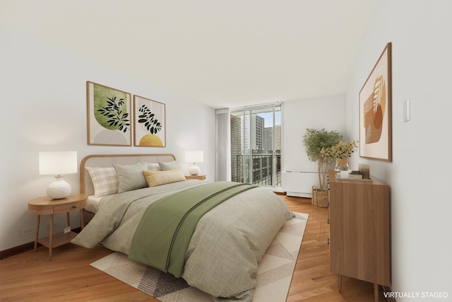 4170 N Marine Dr Unit 6L, Chicago, IL 60613 - bedroom with access to outside, a wall of windows, baseboards, and light wood-style flooring
