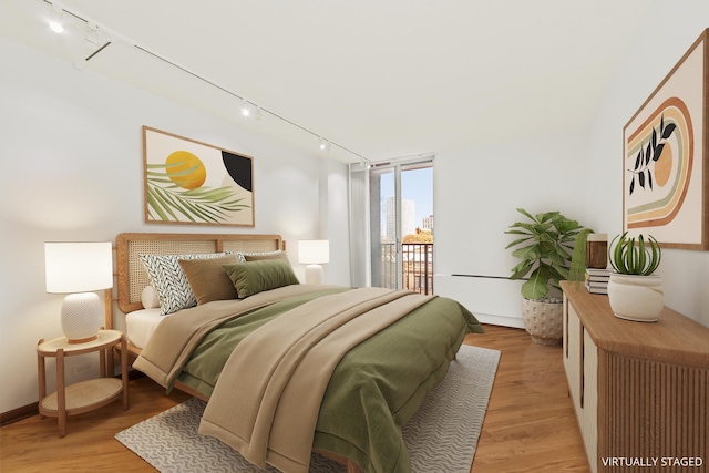 4170 N Marine Dr Unit 6L, Chicago, IL 60613 - bedroom with track lighting, light wood finished floors, baseboards, and access to exterior