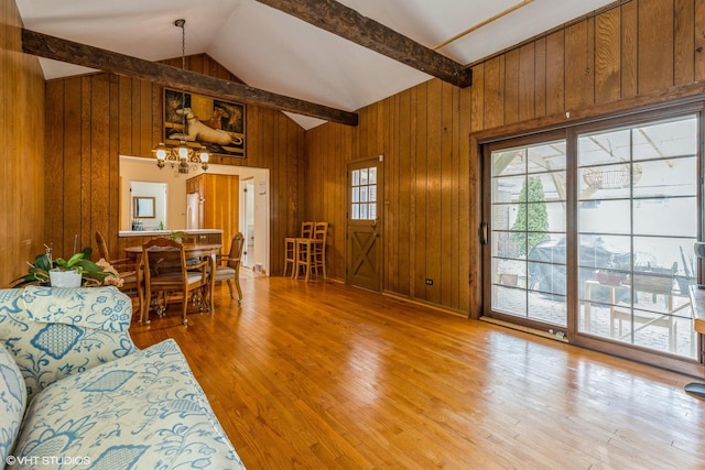 9445 Le Claire Ave, Skokie, IL 60077 - living area featuring a chandelier, wood walls, and light wood-style flooring