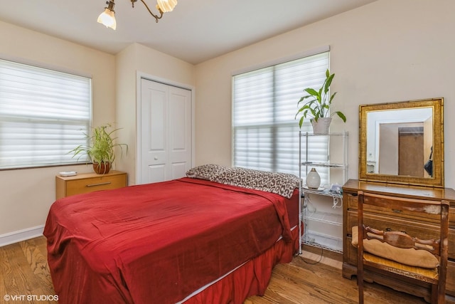 9445 Le Claire Ave, Skokie, IL 60077 - bedroom featuring wood finished floors, multiple windows, and a closet