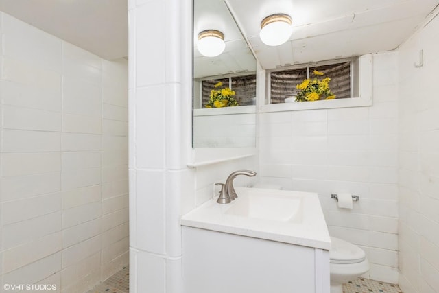 9445 Le Claire Ave, Skokie, IL 60077 - full bathroom featuring vanity, a tile shower, tile walls, and tile patterned floors