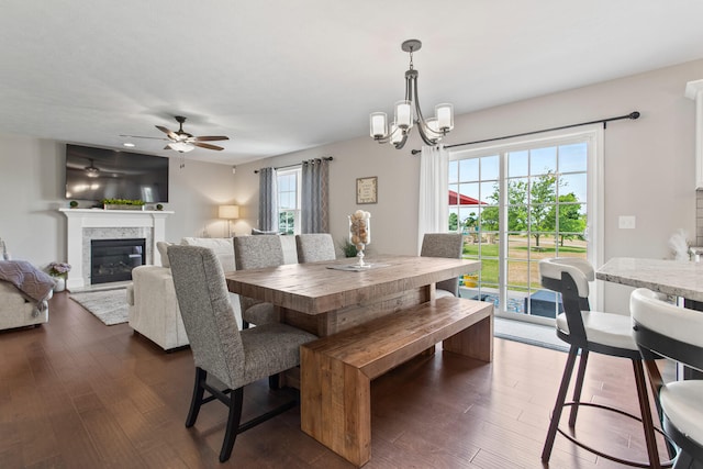 1607 Peppermill Ln, Champaign, IL 61822 - dining space featuring a chandelier, dark wood-type flooring, a glass covered fireplace, and a ceiling fan