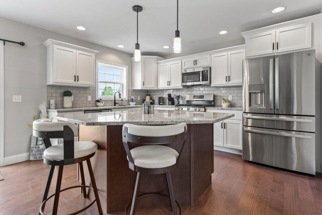 1607 Peppermill Ln, Champaign, IL 61822 - kitchen with stainless steel appliances, a center island, dark wood-type flooring, white cabinetry, and recessed lighting