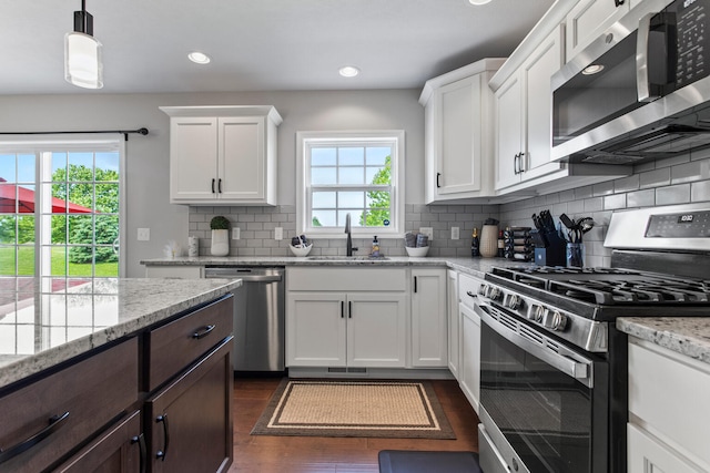 1607 Peppermill Ln, Champaign, IL 61822 - kitchen with appliances with stainless steel finishes, dark wood-style floors, white cabinets, dark brown cabinets, and recessed lighting