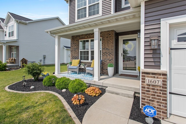 1607 Peppermill Ln, Champaign, IL 61822 - entrance to property with covered porch, a yard, and brick siding