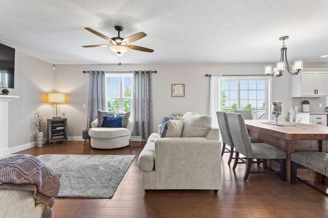 1607 Peppermill Ln, Champaign, IL 61822 - living room with ceiling fan, a chandelier, and dark wood finished floors